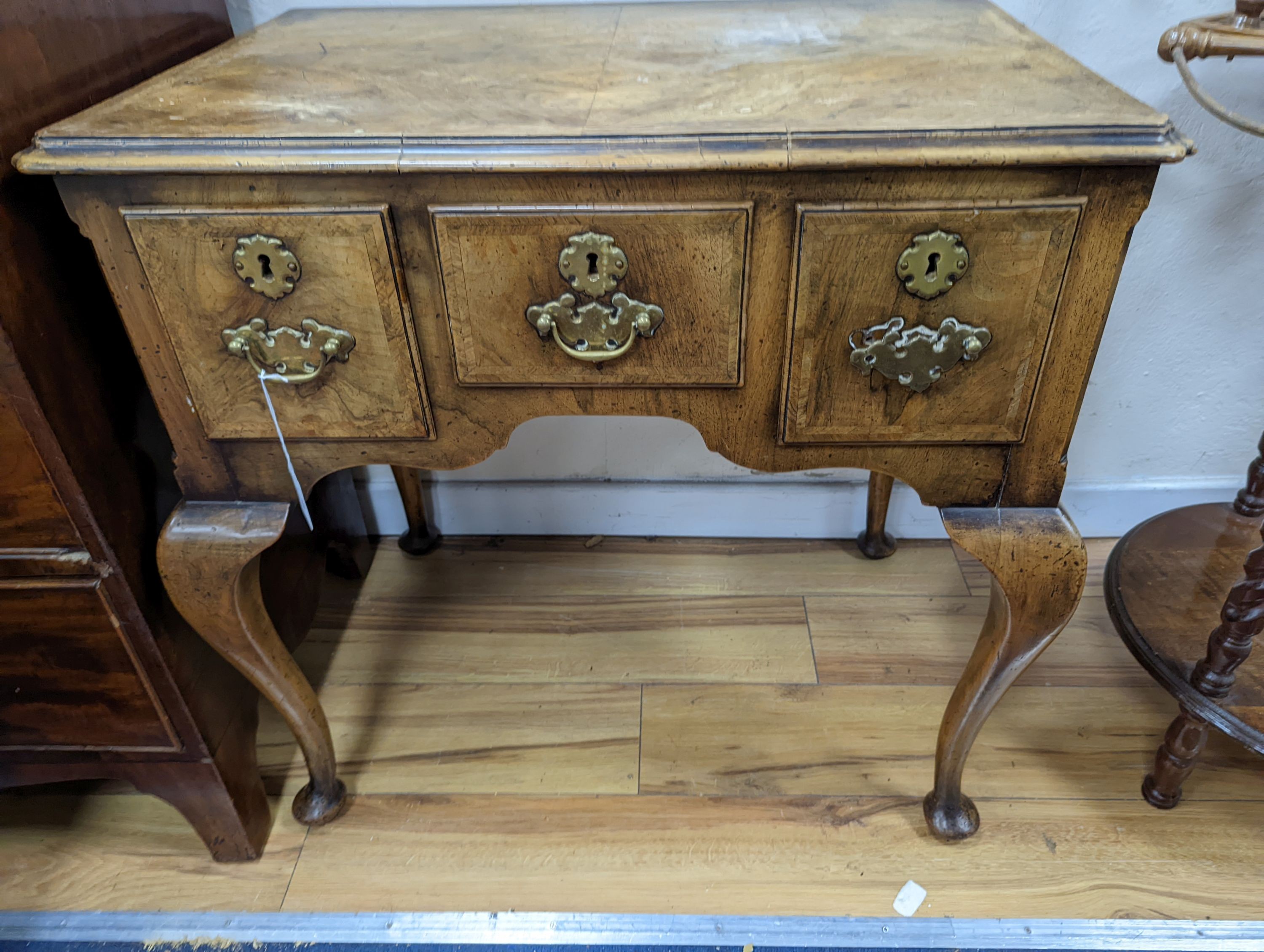 A 1920's Queen Anne revival banded walnut lowboy, width 76cm, depth 51cm, height 75cm together with a similar rectangular walnut dressing stool